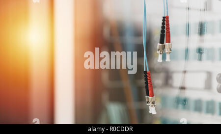 Pair of fiber optic cables with FC type connectors in server room, technology and data line. IT background with copy space Stock Photo