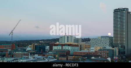 The moon going down over the city of Sheffield at Dawn, South Yorkshire, UK Stock Photo