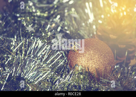 Closeup of Christmas-tree decorations, gold christmas background sparkles