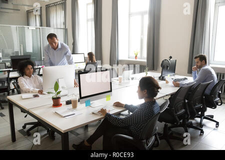 Diverse multi-ethnic people employees working together in shared Stock Photo