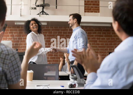 Happy ceo team congratulating successful african worker with job Stock Photo
