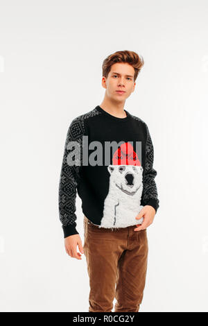 The young man in cozy bear sweater on white background Stock Photo