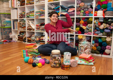 Woman shows off her amazing collection of swatches and fat quarters Stock Photo