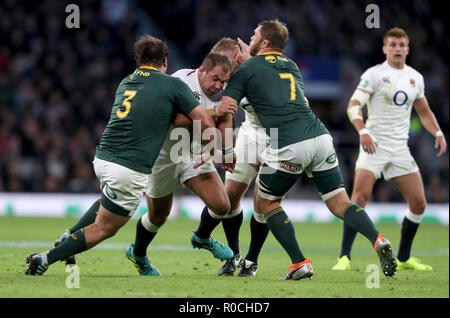 England's Ben Moon (2nd left) is tackled by South Africa's Frans Malherbe (left) and Duane Vermeulen during the Autumn International match at Twickenham Stadium, London.