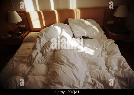 Hotel bedroom with messy double bed Stock Photo