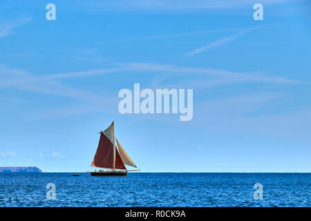 Gaff rigged traditional sailing boat sailing along the English Channel off Cornwall Stock Photo