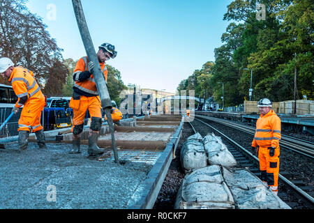 Rail Construction workers building a new platform in station Stock Photo