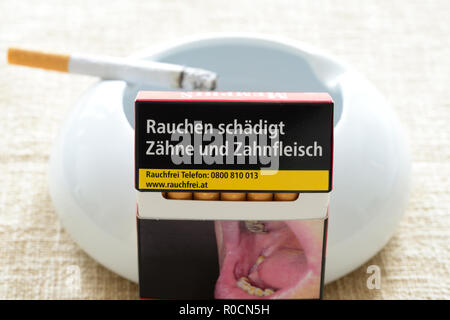 Pack of cigarettes with the warning smoking harms teeth and gums. Stock Photo