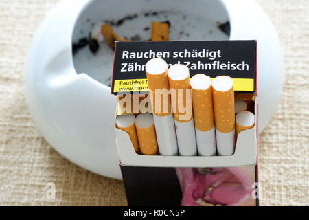 Pack of cigarettes with the warning smoking harms teeth and gums. Stock Photo