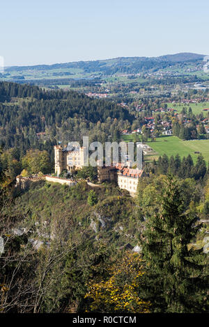 View from a path around the Lake Alpsee to Hohenschwangau Castle,  Alterschrofen, Fuessen and lake Forggensee in autumn. Schwangau, Germany, 2018 Stock Photo