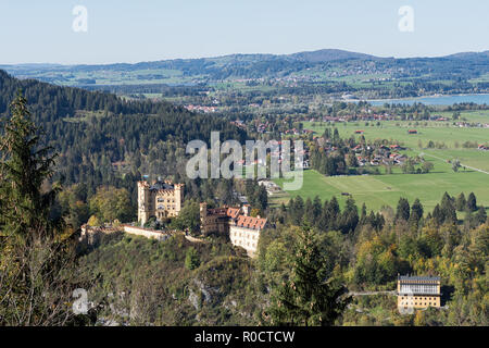 View from a path around the Lake Alpsee to Hohenschwangau Castle,  Alterschrofen, Fuessen and lake Forggensee in autumn. Schwangau, Germany, 2018 Stock Photo