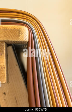 Pieces of leather in various colors on a workbench in a handbag design studio Stock Photo