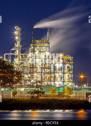 Night scene of detail of a heavy Chemical Industrial plant with mazework of pipes and pipelines in twilight Stock Photo