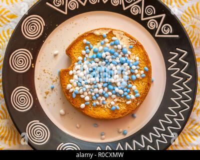 Rusks with white and blue anise seed sprinkles served in Holland when a baby is born, on a white background Stock Photo