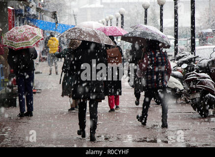 Srinagar, Jammu and Kashmir, India. 3rd Nov, 2018. People walk as it snows in Srinagar the summer capital of Indian controlled Kashmir on November 03, 2018. The season's first snowfall has forced authorities to suspend vehicular traffic on Srinagar-Jammu National Highway.Air traffic was also stopped due to snowfall with several flights cancelled, the officials said. Credit: Faisal Khan/ZUMA Wire/Alamy Live News Stock Photo