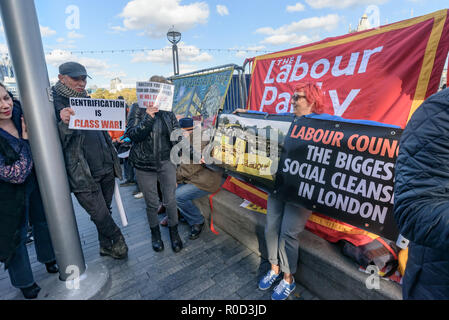 London, UK. 3rd November 2018. Class War supporters came to the 'No Demolitions Without Permission' housing protest at City Hall with banners declaring that Labour Councils were the biggest social cleansers in London and 'Labour, Labour Home Snatchers! Even Worse Than Maggie Thatcher', pointing out that it was largely Labour councils who were demolishing council estates so that developers could replace council houses with large numbers of properties sold at high market prices and a miserably small number of homes at social rent, promoting schemes which cut by thousands the number of council ho Stock Photo