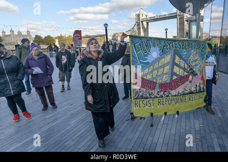 London, UK. 3rd November 2018. At the end of the rally people march around City Hall.Several hundred people, mainly from London's council estates under threat of demolition by Labour London councils came to a protest outside City Hall called by 'Axe the Housing Act'. The protest called for an end to estate demolitions unless  approved by a ballot of all residents, and for public land to be used to build more council homes rather than being turned over to developers to make huge profits from high-priced flats.  Credit: Peter Marshall/Alamy Live News Stock Photo
