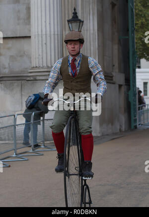 Hyde Park,London,UK,4th November 2018,A man rides a Penny Farthing bike in the London to Brighton Veteran Car Run which gets underway from Hyde Park on its 122nd Anniversary its the World’s longest running motoring event. Veteran cars make the run down to Brighton to hopefully cross the Finish Line in Madeira Drive with spectators lining the route. Credit: Keith Larby/Alamy Live News Stock Photo