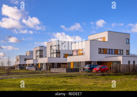 Modern geometric family houses along a green modern residential suburban street, Groningen, Netherlands Stock Photo