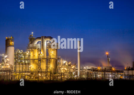 Landscape of a heavy Chemical Industrial plant with mazework of pipes in twilight night scene
