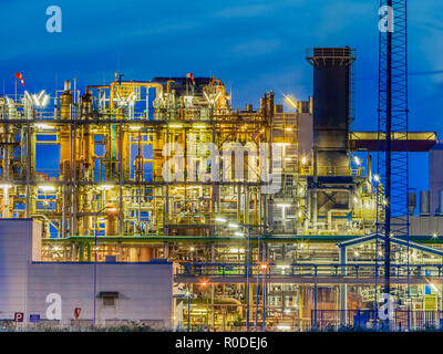 Framework in a heavy Chemical Industrial plant  with mazework of tubes and pipes during twilight Stock Photo