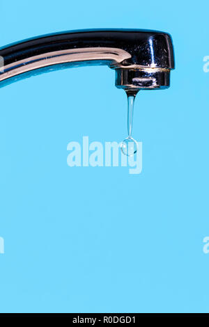 A drop of water dripping from a tap Stock Photo