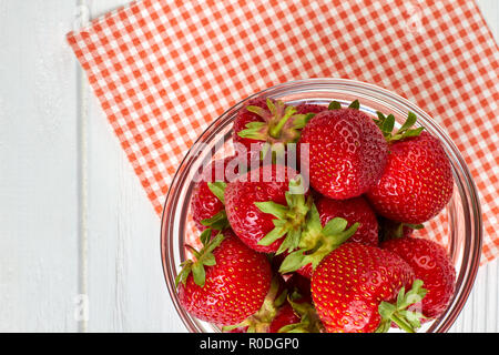 Fresh delicious strawberries in bowl, top view. Stock Photo