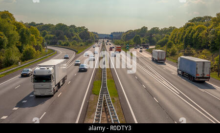 Right hand side Evening Traffic on the A12 Motorway through the Veluwe forest. One of the Bussiest highways in the Netherlands Stock Photo