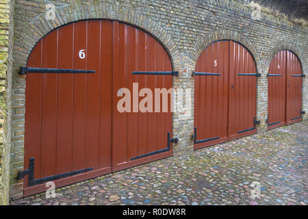 Red Doors of a Historic Ammunition Depot used as Wine Cellar in the Fortified Town of Bourtange Stock Photo