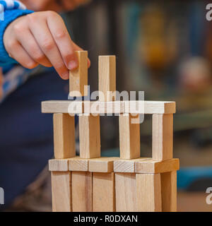 Boy Building a Structure from Wooden Building Blocks Stock Photo