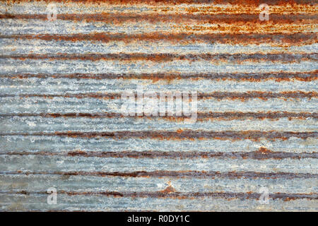 Fragment of old ribbed metal plate covered with several layers of shelled paint Stock Photo