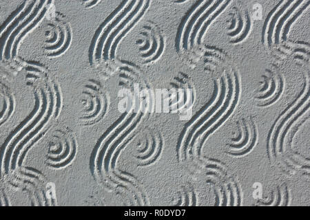 Part of relief concrete stucco wall with wavy ornament close up Stock Photo