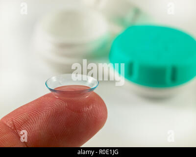 Contact lens on finger tip wit white background Stock Photo