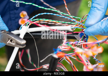 Fiber optic, technicians are install cabinet on fiber optic cable. Blur images with back lighting. Stock Photo