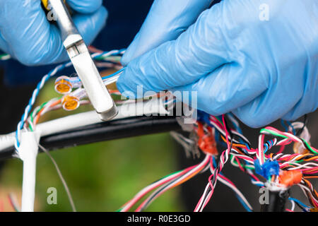 Fiber optic, technicians are install cabinet on fiber optic cable. Blur images with back lighting. Stock Photo
