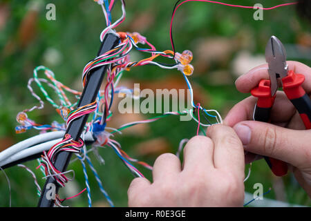 Fiber optic, technicians are install cabinet on fiber optic cable. Blur images with back lighting. Stock Photo