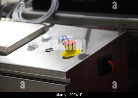 Emergency ON/OFF industrial switch of a food industry equipment. Emergency stop Stock Photo