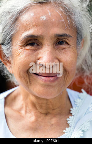 NAKHON PATHOM, THAILAND, JANUARY 16, 2016 : A beautiful senior Thai lady is posing near the Wat Samphran temple in Nakhon Pathom near Bangkok, Thailan Stock Photo