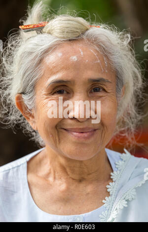 NAKHON PATHOM, THAILAND, JANUARY 16, 2016 : A beautiful senior Thai lady is posing near the Wat Samphran temple in Nakhon Pathom near Bangkok, Thailan Stock Photo