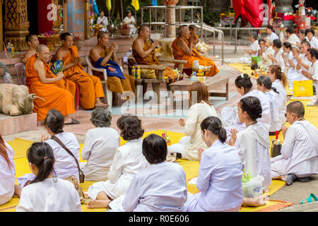 NAKHON PATHOM, THAILAND, JANUARY 16, 2016 : Buddhist monks and women are chanting and praying outside the Wat Samphran temple in Nakhon Pathom near Ba Stock Photo