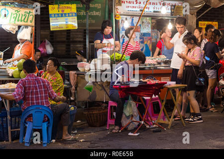 BANGKOK, THAILAND, February 18, 2015 : Some customers are sitting at the restaurant tables in a street of Chinatown in Bangkok, Thailand Stock Photo