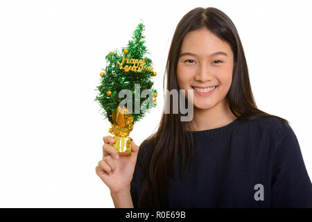 Young happy Asian teenage girl smiling and holding Happy New Yea Stock Photo