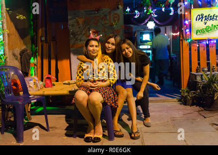 LAEM CHABANG, THAILAND, DECEMBER 26 : Thai women are sitting in front of a traditional Thai Karaoke wooden house in the city of Laem Chabang, Thailand Stock Photo