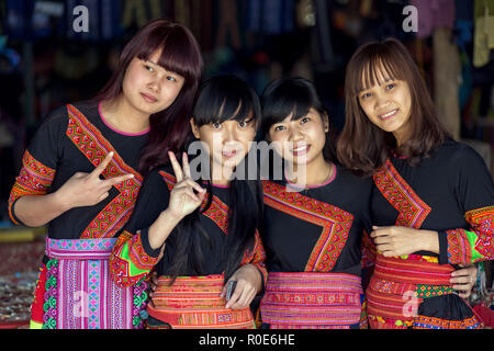 MAI CHAU, VIETNAM, DECEMBER 20, 2015 : Group of tourists Vietnamese girls wearing traditional Hmong ethnicity costume, posing in the village of Mai Ch Stock Photo