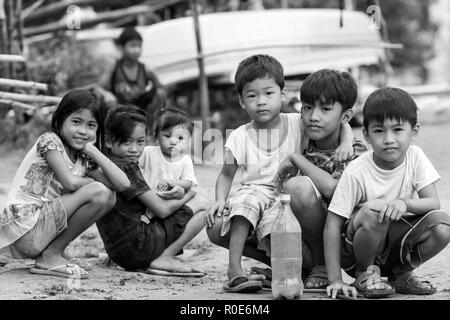 EL NIDO, PHILIPPINES, JANUARY 11 :Filipino kids sitting in a poor village in El Nido,  Palawan island, Philippines, on january 11, 2014 Stock Photo