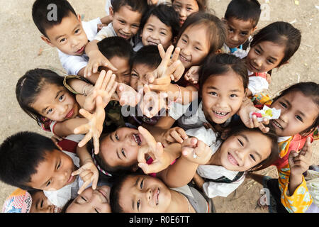 Siem reap -december 04: group of joyful kids posing in a schoolyard on december 04, 2012 in siem reap, cambodia Stock Photo