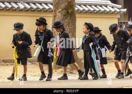 NARA,JAPAN, NOVEMBER 18, 2011: Japanese young students are coming back from elementary school in Nara near Kyoto, Japan. Stock Photo