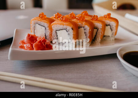 Philadelphia roll sushi cucumber, avocado, cream cheese, red caviar. Sushi menu Stock Photo