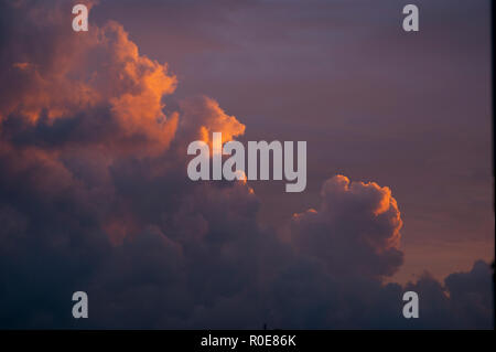 Cumulus type clouds on sunset with warm colors. Stock Photo