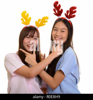 Two young happy Asian teenage girls smiling and posing together  Stock Photo